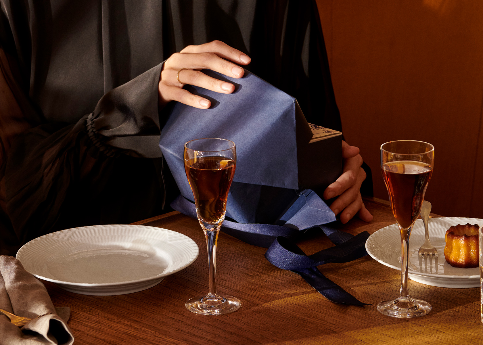 A Royal Copenhagen Gift is being unwrapped from its Blue paper